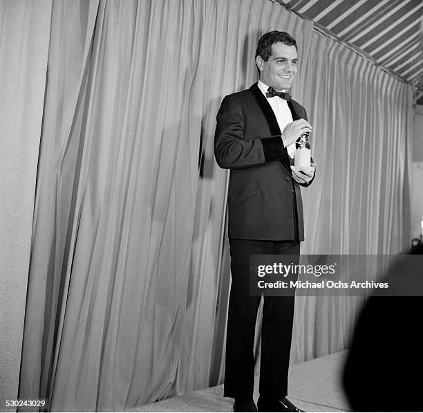 Actor Omar Sharif poses with his Golden Globe Awards for "Lawrence of Arabia" in Los Angeles,CA.