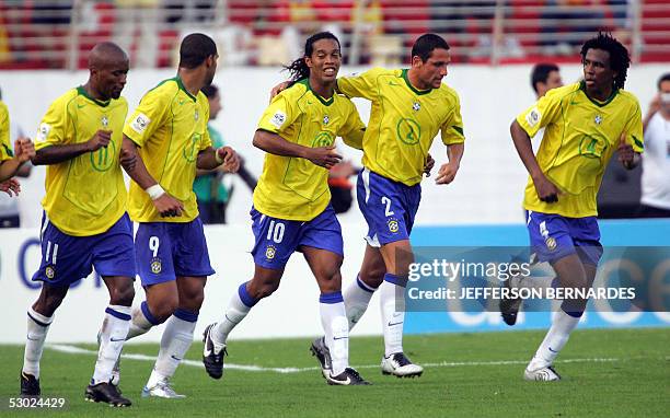 Brazilian soccer striker Ronaldinho Gaucho celebrates a goal against Paraguay with his teammates, 05 June 2005, during their Germany 2006 FIFA World...