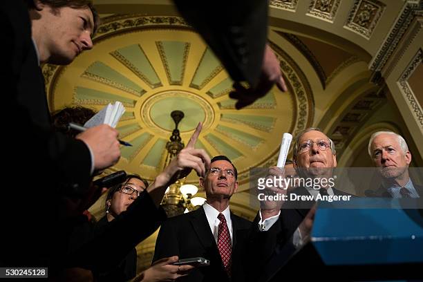 Sen. John Barrasso , Senate Majority Leader Mitch McConnell and Sen. John Cornyn listen to questions from reporters during news conference after...