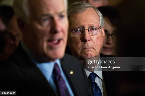 Sen. John Cornyn speaks as Senate Majority Leader Mitch McConnell looks on as they speak to reporters during a news conference after their weekly...