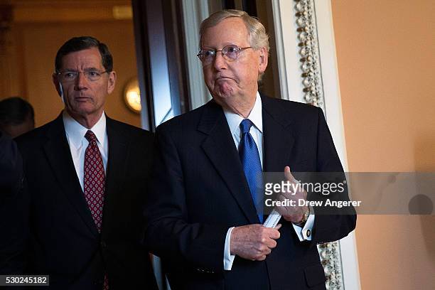 Sen. John Barrasso and Senate Majority Leader Mitch McConnell emerge from a closed-door weekly policy meeting with Senate Republicans, at the U.S....