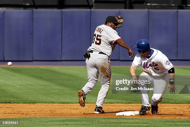 David Wright of the New York Mets is safe at second after shortstop Deivi Cruz of the San Francisco Giants misses the ball during the first game of...