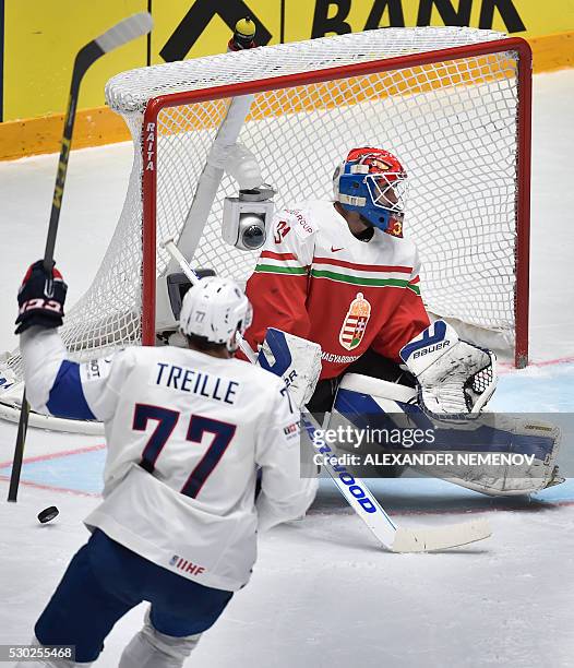 France's forward Sacha Treille scores past Hungary's goalie Miklos Rajna during the group B preliminary round game Hungary vs France at the 2016 IIHF...