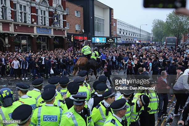 Police horses charge as West Ham fans become violent and start throwing bottles at police outside the West Ham United FC's Boleyn Ground on May 10,...