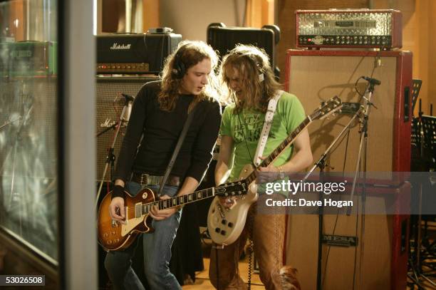 Brothers Dan and Justin Hawkins of English cod-metal band The Darkness recording guitar parts for the Band Aid 20 charity single, 'Do They Know It's...