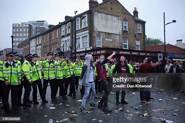 Police officers dodger projectiles as West Ham fans become violent and start throwing bottles at police outside the West Ham United FC's Boleyn...