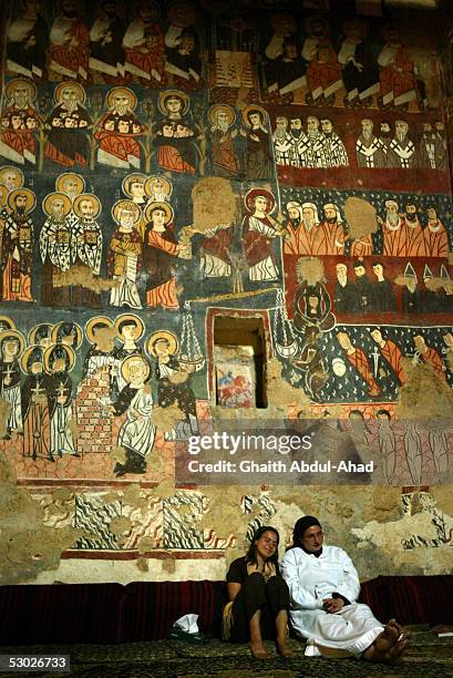 Syrian Orthodox nun and an American Catholic worshiper sit next each other during prayers in the church in the Monastery of St. Moses the Abyssinian...