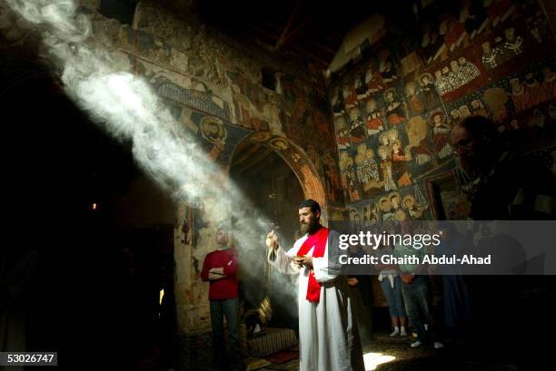 Brother Putros, a Syrian monk, swings incense durring mass in the church of the Monastery of St. Moses the Abyssinian May 19, 2005 east of Nebek,...