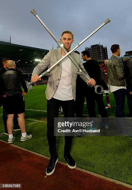 Jack Collison makes the crossed Hammers sign with his crutches prior to the Barclays Premier League match between West Ham United and Manchester...