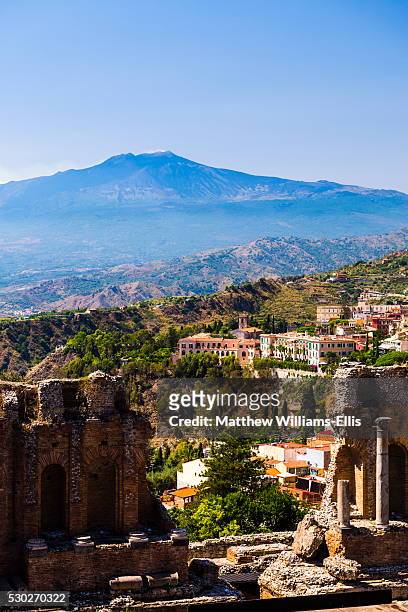 mount etna volcano with ruins of teatro greco (ancient theatre) of taormina in the foreground, sicily, italy, europe - teatro greco taormina bildbanksfoton och bilder