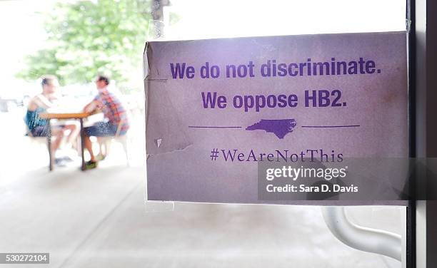 The "We Are Not This" slogan is posted at the entrances to Bull McCabes Irish Pub on May 10, 2016 in Durham, North Carolina. Debate over transgender...