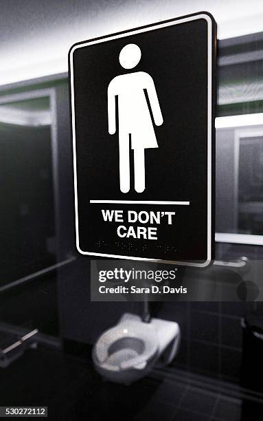 Gender neutral signs are posted in the 21C Museum Hotel public restrooms on May 10, 2016 in Durham, North Carolina. Debate over transgender bathroom...