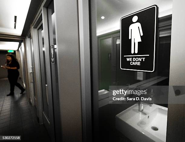 Gender neutral signs are posted in the 21C Museum Hotel public restrooms on May 10, 2016 in Durham, North Carolina. Debate over transgender bathroom...