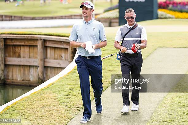 Justin Rose of England walks with coach Sean Foley off the 17th hole island green ahead of THE PLAYERS Championship on THE PLAYERS Stadium Course at...