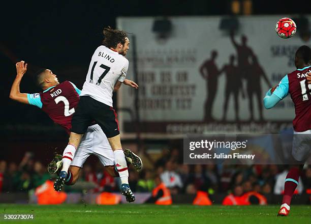 Winston Reid of West Ham United beats Daley Blind of Manchester United to score their third goal during the Barclays Premier League match between...