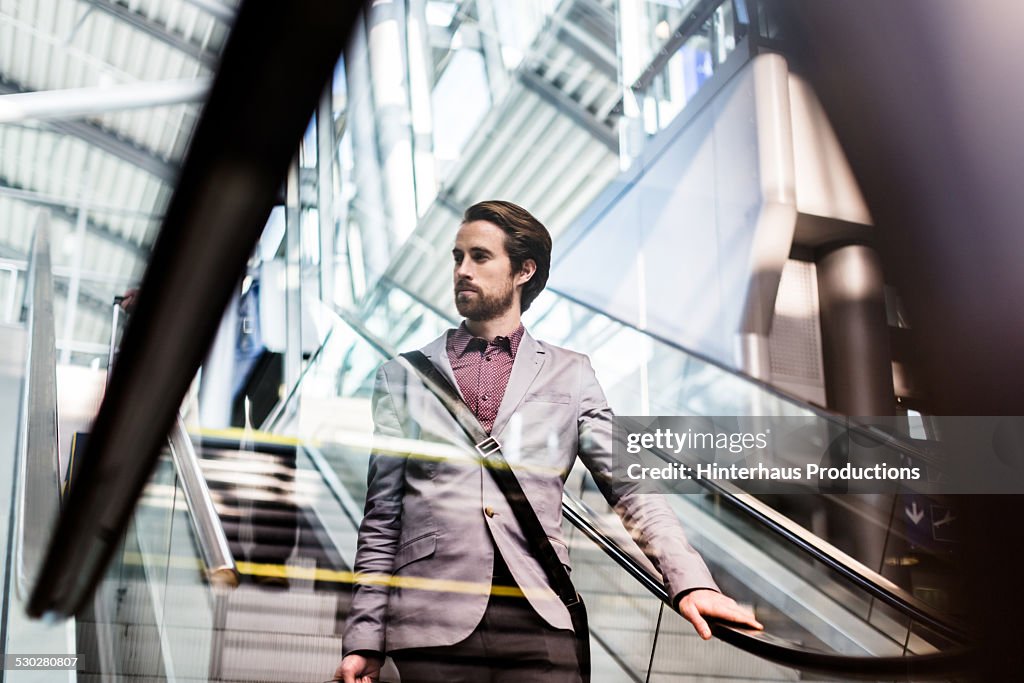 Casual Businessman On Escalator At Airport