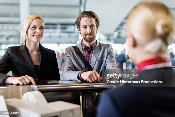 two business travellers at check-in counter - airport check in stock-fotos und bilder