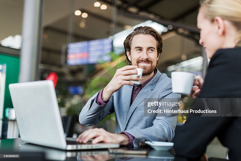 Travellers Having Business Meeting At The Airport