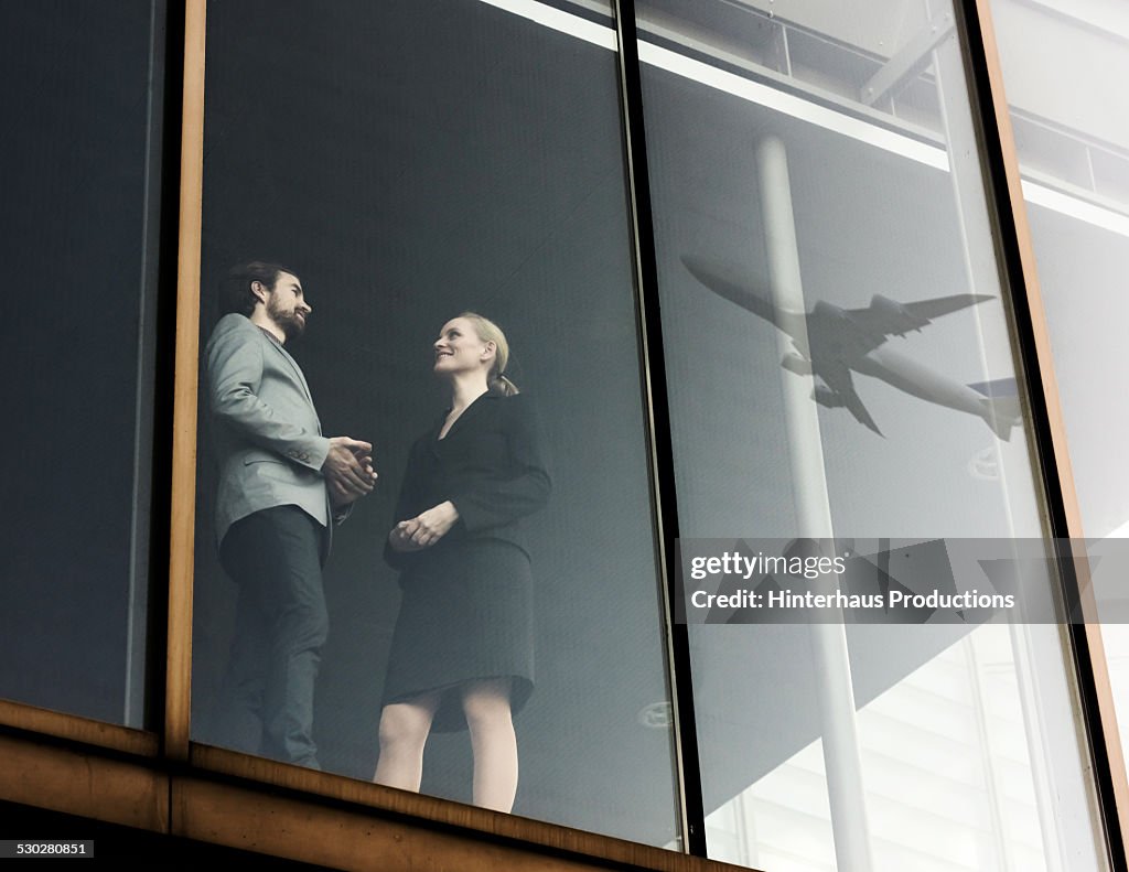 Business Travellers With Airplane Reflecting