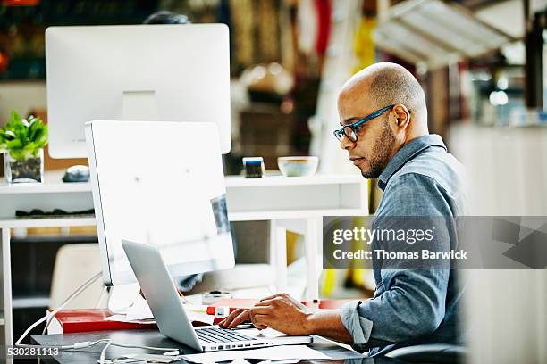 businessman at workstation in startup office - authority stock pictures, royalty-free photos & images