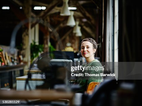 Smiling businesswoman sitting at workstation