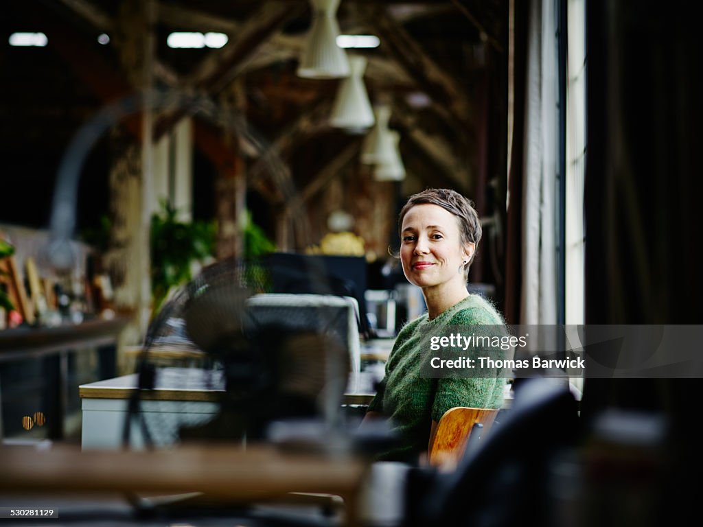 Smiling businesswoman sitting at workstation