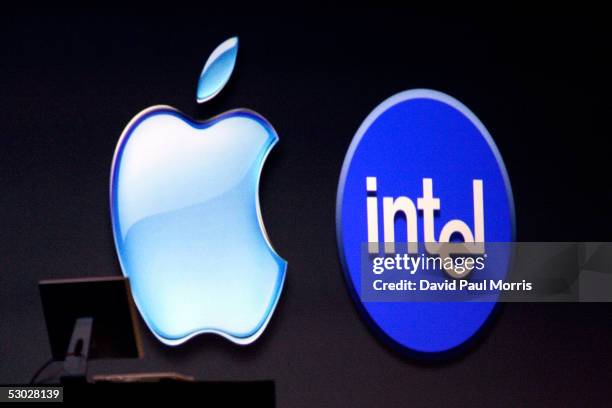 The Apple and Intel logos appear on a screen during the keynote speech at the Apple Worldwide Developers conference with his keynote speech June 6,...