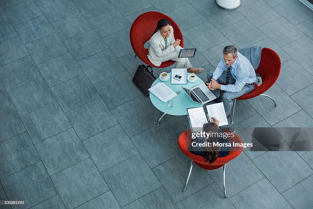 Businesspeople discussing strategy at coffee table