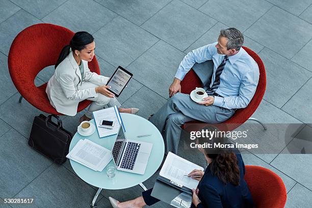 businesspeople discussing strategy in office - red background stock pictures, royalty-free photos & images