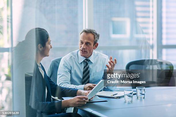 businesspeople discussing strategy in office - formal businesswear stock pictures, royalty-free photos & images