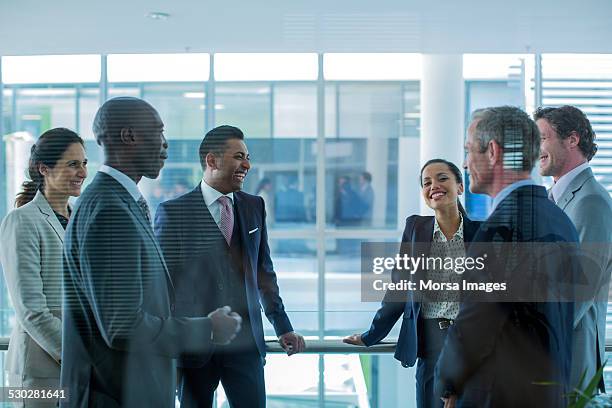 businesspeople discussing in office - meeting candid office suit stockfoto's en -beelden