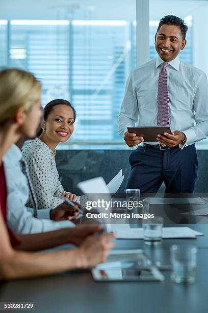 businessman discussing during presentation - boardroom ipad stock-fotos und bilder