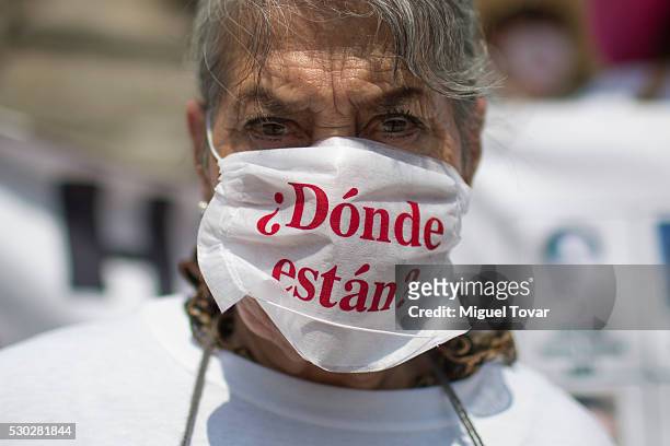 Woman wears a mask that reads "¿Donde están?" during a march on Mother's Day on May 08, 2016 in Mexico City, Mexico. Mothers and other relatives of...