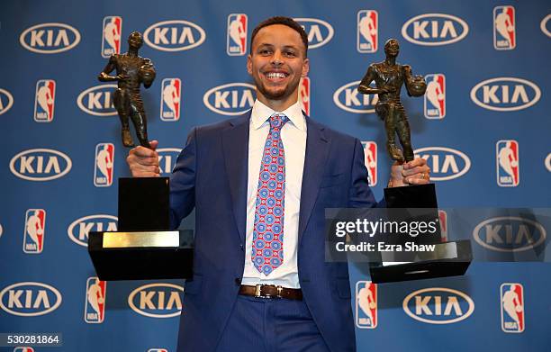 Stephen Curry of the Golden State Warriors poses with his back-to-back NBA Most Valuable Player Awards following a press conference at ORACLE Arena...
