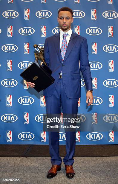 Stephen Curry of the Golden State Warriors stands with his NBA Most Valuable Player Award following a press conference at ORACLE Arena on May 10,...