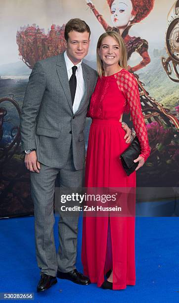 Ed Speleers and wife Asia Macey attend the European Film Premiere of "Alice Through The Looking Glass" at Odeon Leicester Square on May 10, 2016 in...