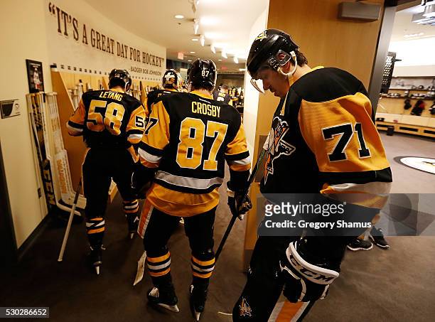 Kris Letang, Sidney Crosby and Evgeni Malkin of the Pittsburgh Penguins prepare to take the ice for warmups prior to the game against the Washington...