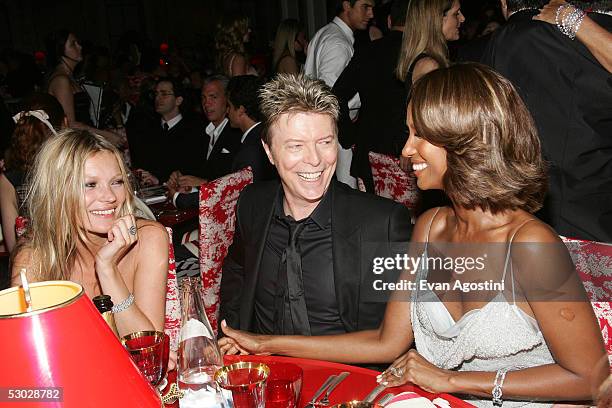 Kate Moss, David Bowie and his wife Iman pose for a photo at the 2005 CFDA Awards dinner party at the New York Public Library June 6, 2005 in New...