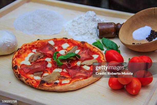 set of typical italian products of bresaola of valtellina, pizza with mushrooms, tomatoes from sicily, mozzarella from naples, italy, europe - bresaola stock-fotos und bilder