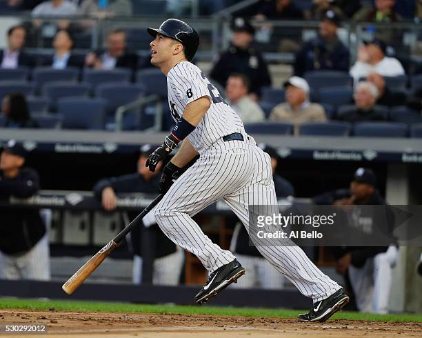Dustin Ackley of the New York Yankees drives in a run with a sacrifice fly in the second inning against the Kansas City Royals during their game at...