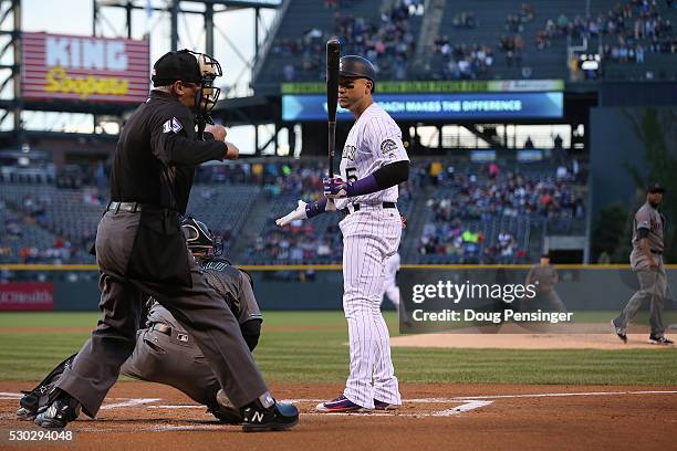 Homeplate umpire John Hirschbeck calls Carlos Gonzalez of the Colorado Rockies out on strikes as he faces starting pitcher Rubby De La Rosa of the...