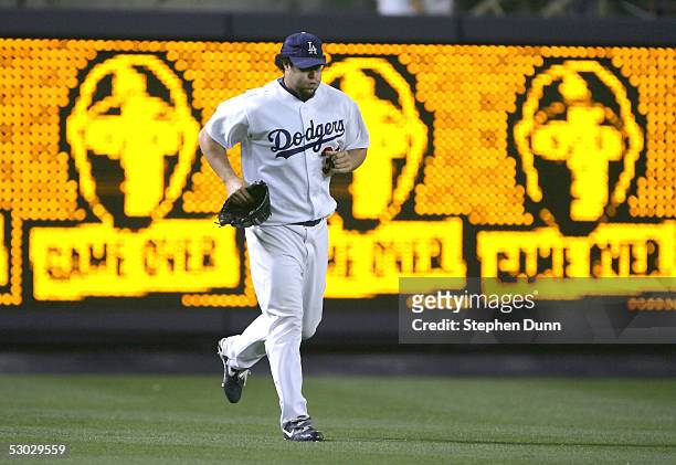 Closer Eric Gagne of the Los Angeles Dodgers enters the game past his video board characatures to pitch the ninth inning against the Detroit Tigers...