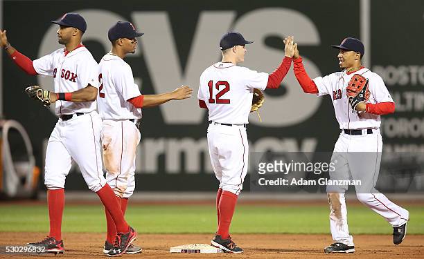 Chris Young, Brock Holt, Mookie Betts and Xander Bogaerts celebrate after their victory over the Oakland Athletics at Fenway Park on May 10, 2016 in...