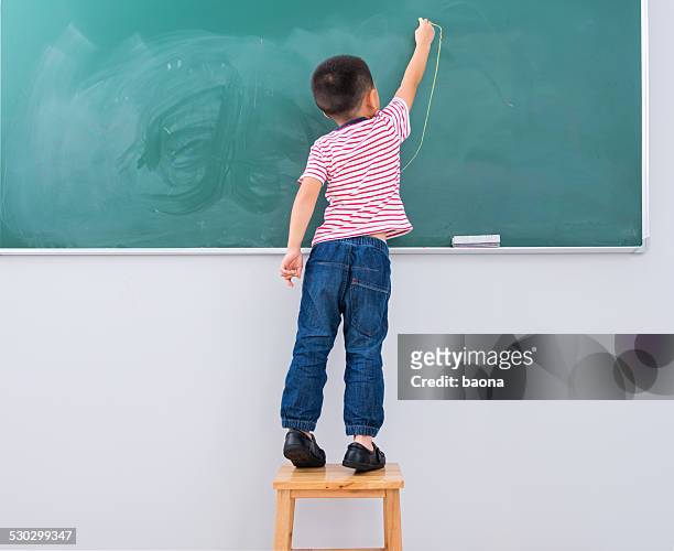 writing on blackboard - child standing stock pictures, royalty-free photos & images