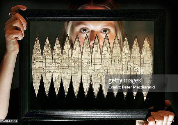 Frances Arnold of Christie's displays the first printed map to show America on June 7, 2005 in London. This map printed by Martin Waldseemuller in...