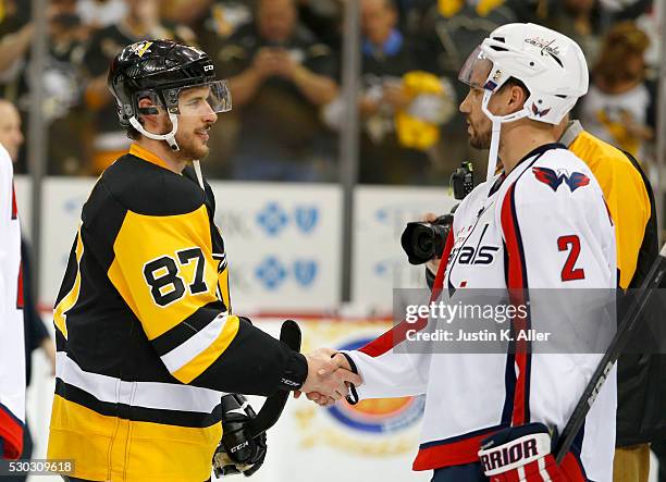 Sidney Crosby of the Pittsburgh Penguins shakes hands with Matt Niskanen of the Washington Capitals after the Penguins defeated the Capitals 4-3 in...