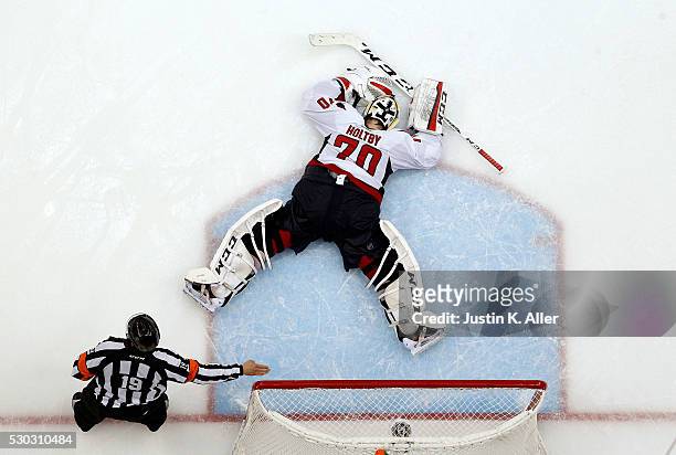Braden Holtby of the Washington Capitals reacts after allowing the game winning overtime goal against Nick Bonino of the Pittsburgh Penguins in Game...