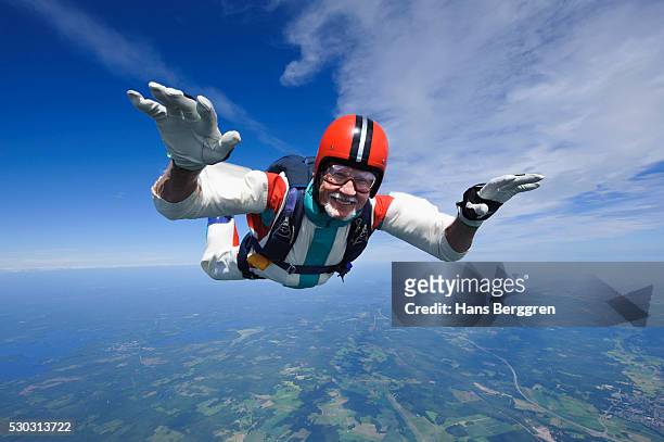 aerial shot of man skydiving - seniors extreme sports stock pictures, royalty-free photos & images