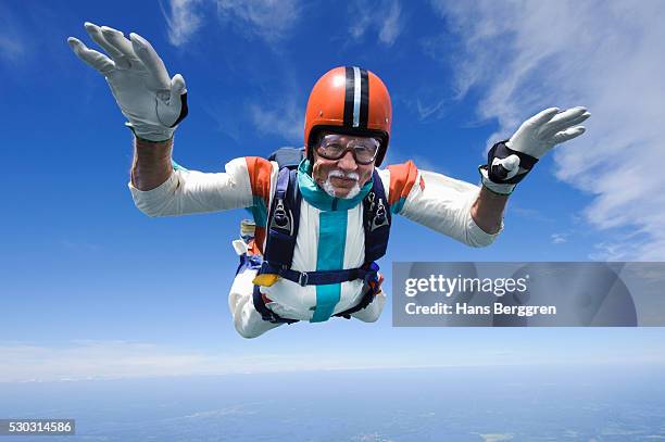 aerial shot of man skydiving - risk stock-fotos und bilder