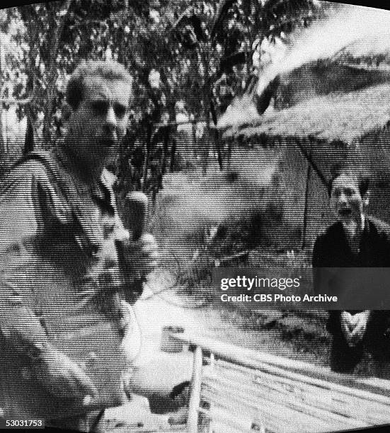 Screen capture of American news broadcaster Morley Safer , correspondent for CBS News, and an unidentified Vietnamese man as Safer reports on the...